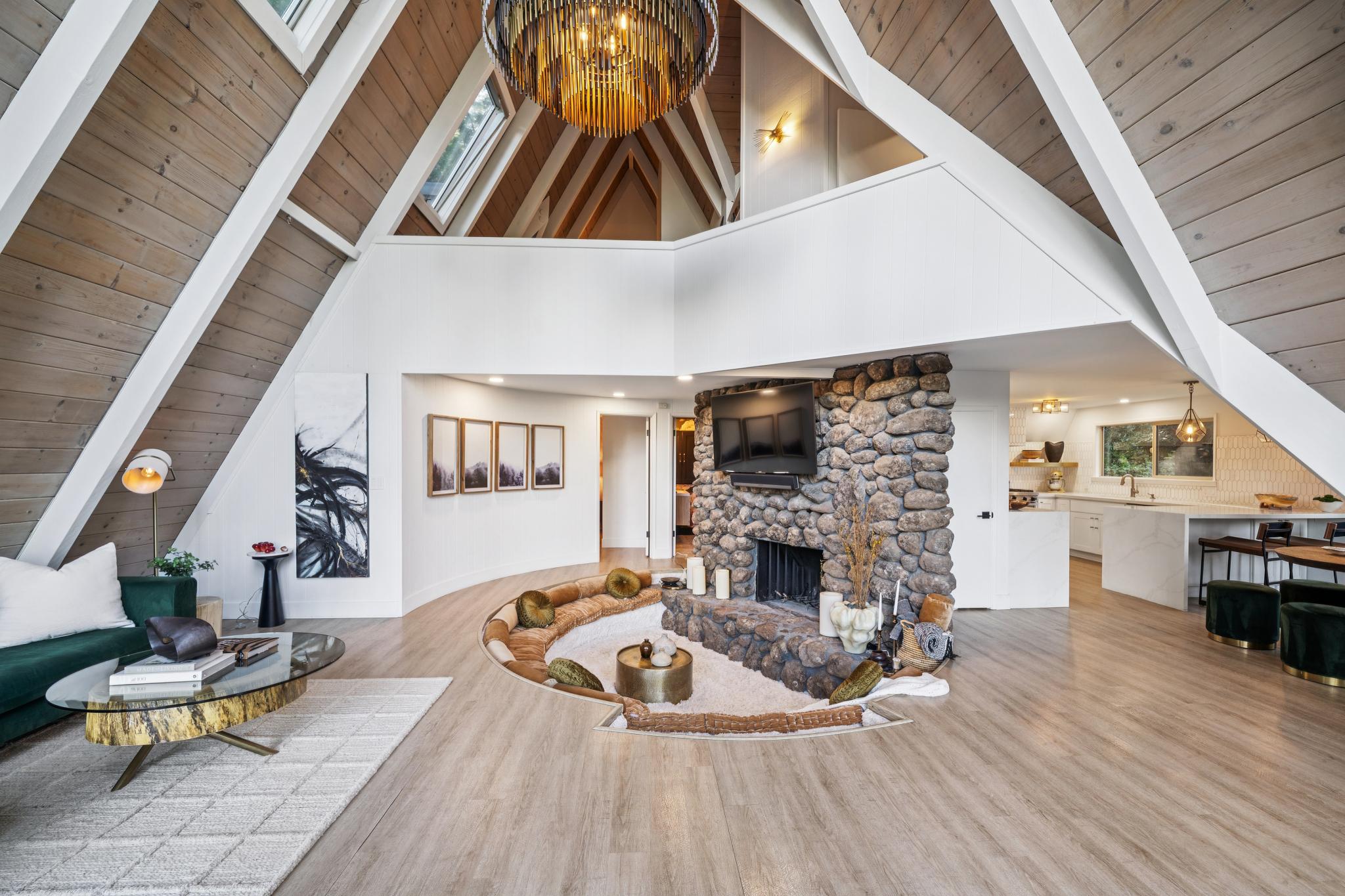 The great room — stone fireplace and soaring ceiling